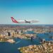 Aerial view of Sydney Harbour featuring the Sydney Opera House and Sydney Harbour Bridge.