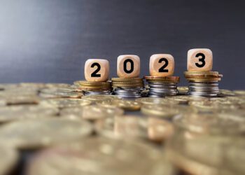 Finance and Economy of New Year Concept. 2023 text on wooden blocks in vintage background.