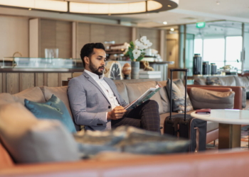 Business travel - Indian businessman waiting in an airport lounge