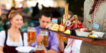 In Beer garden in Bavaria, Germany - beer and snacks are served, focus on meal
